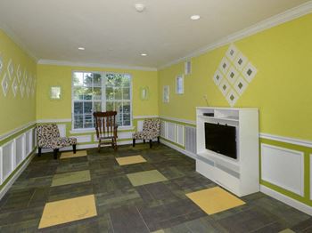 a living room with a fireplace and chairs